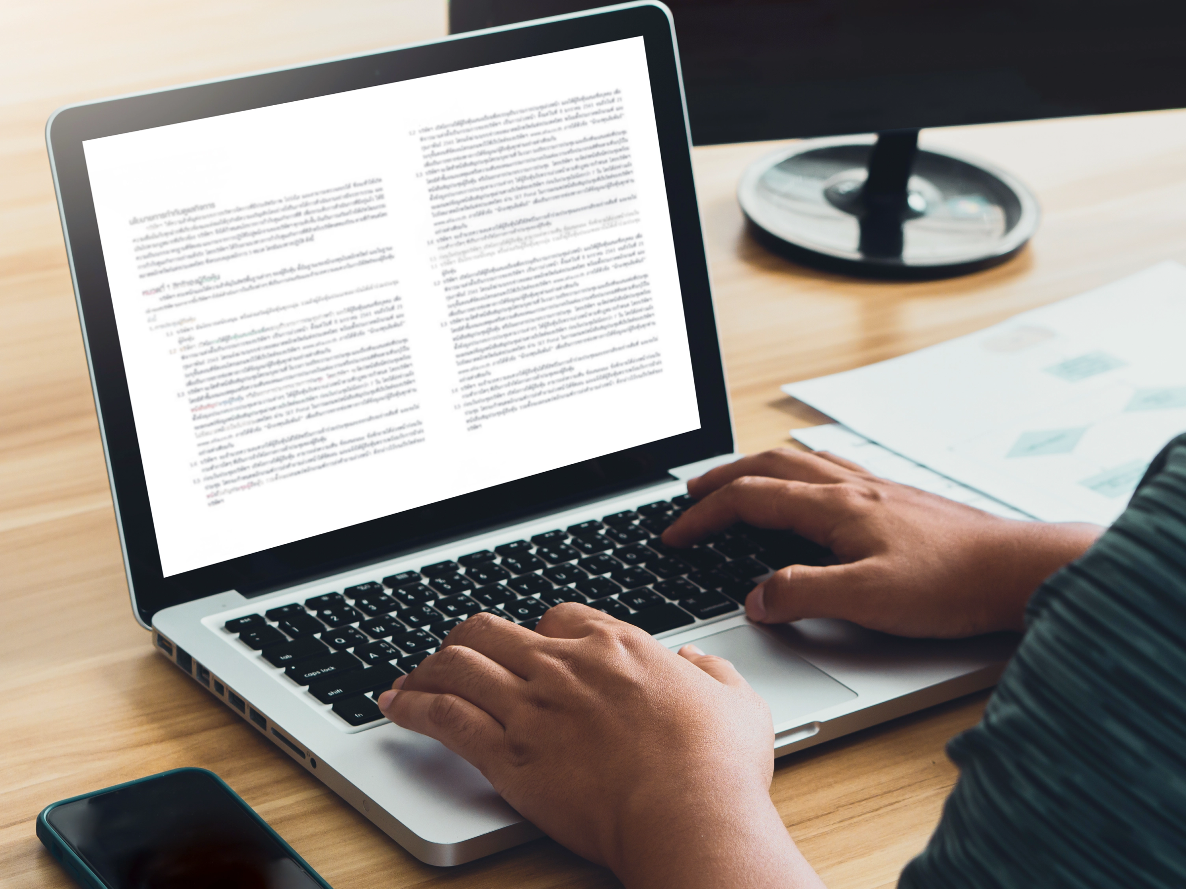A lawyer reviewing a document on-screen with AI-powered proofreading suggestions appearing in the margins.