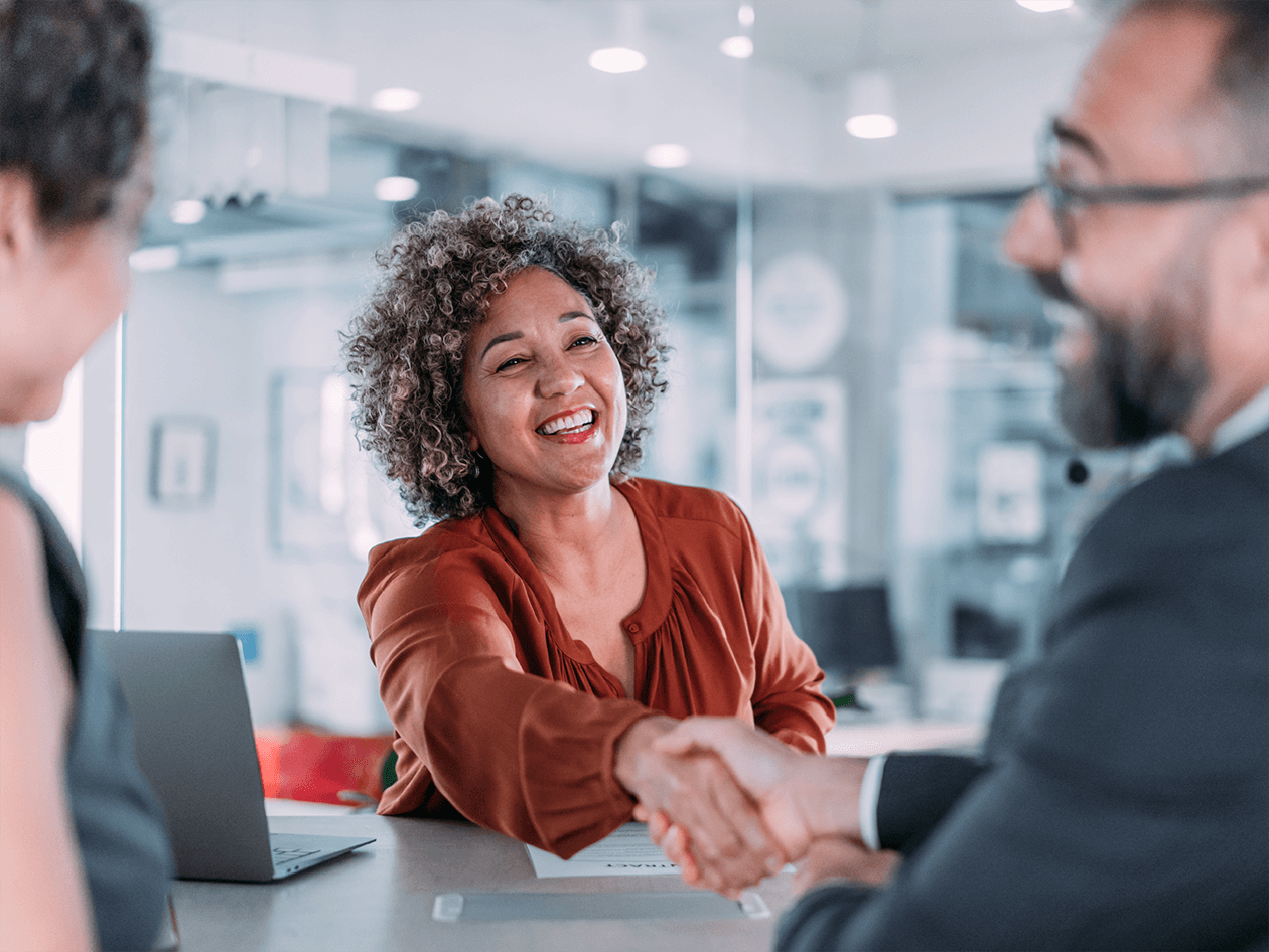 women shaking clients hand