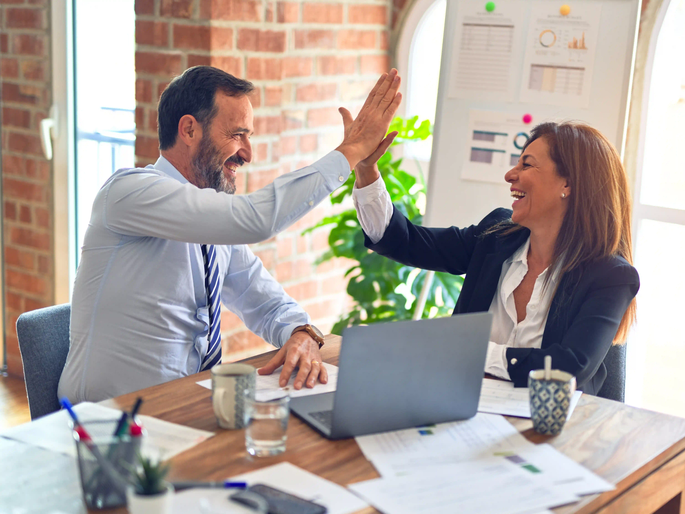 Two colleagues high-fiving