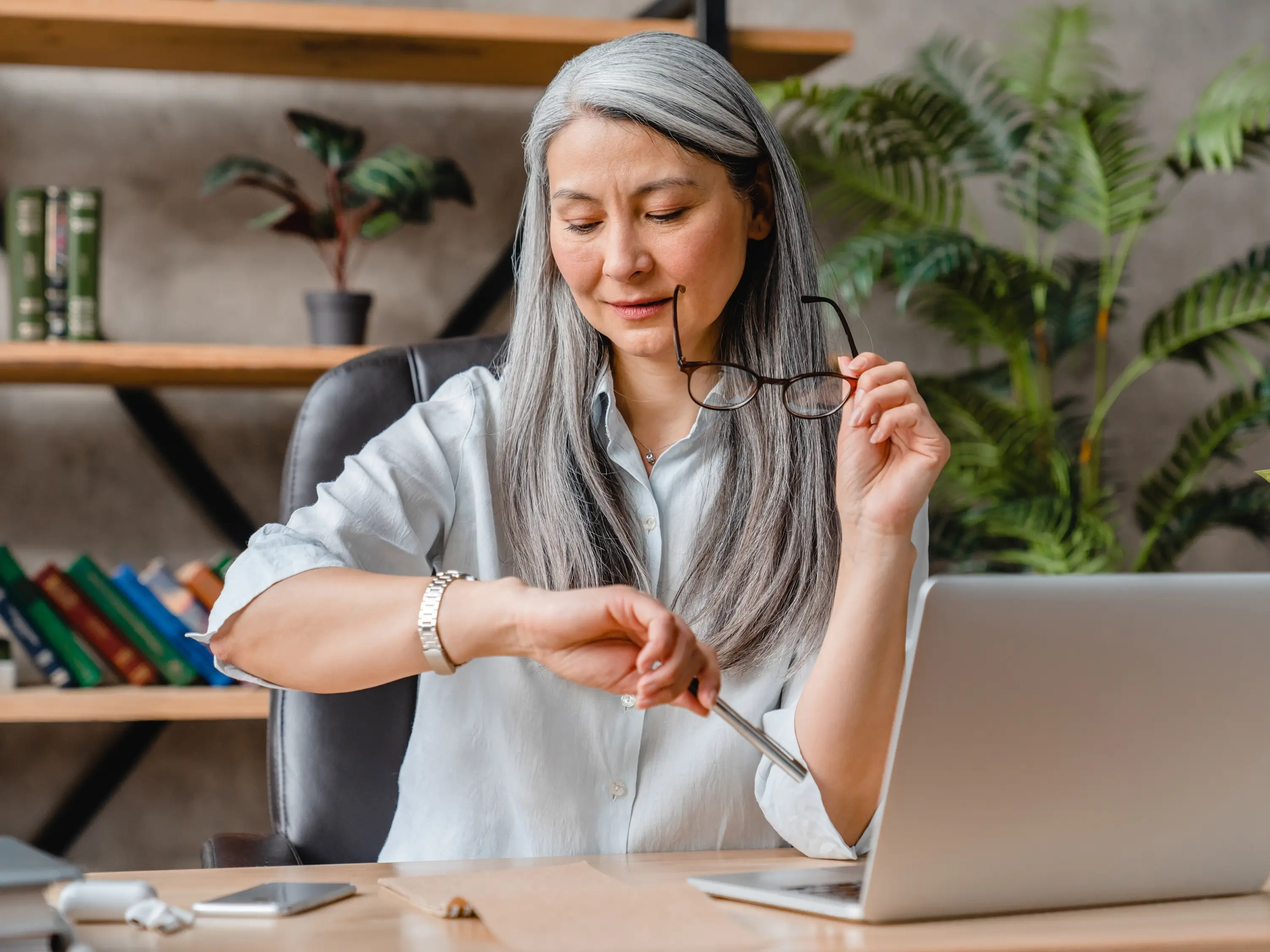 Lawyer checking their watch while sitting in their office