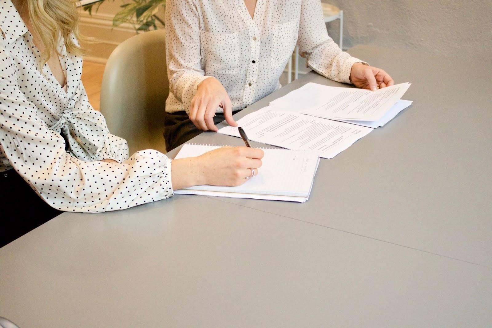 immigration lawyer and client going over the immigration forms to apply for US citizenship