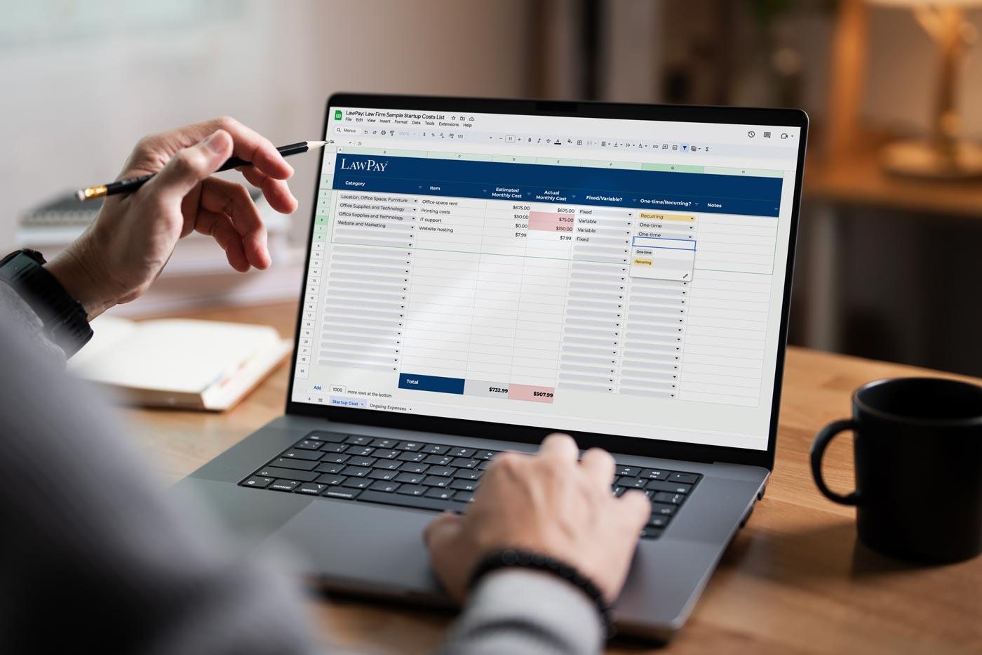 Person filling out a law firm expense tracking template on their laptop