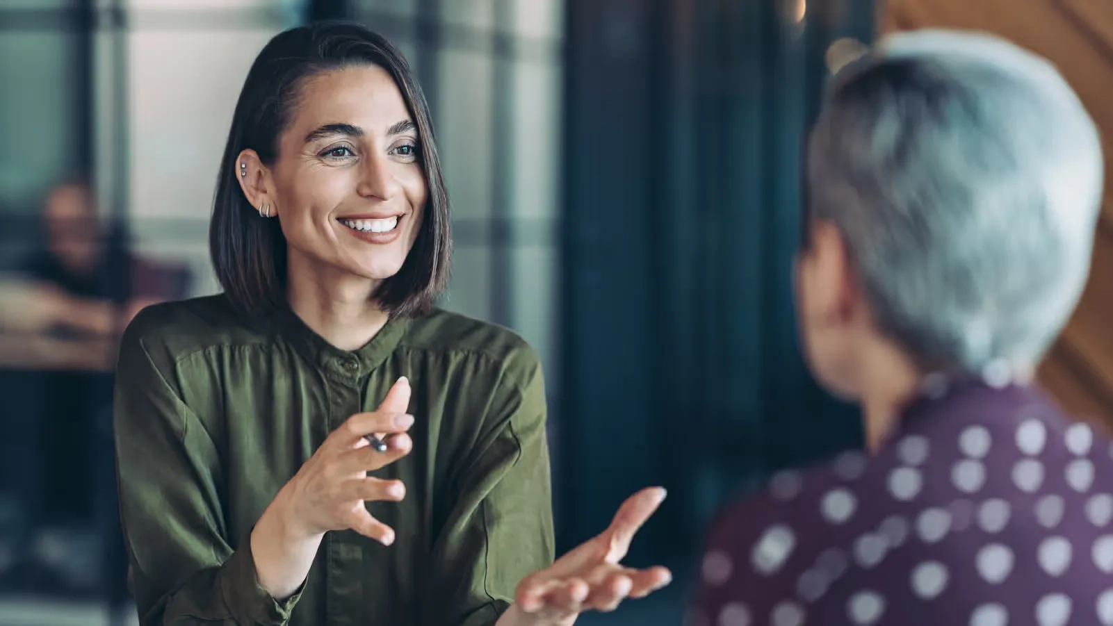 woman discussing with another woman