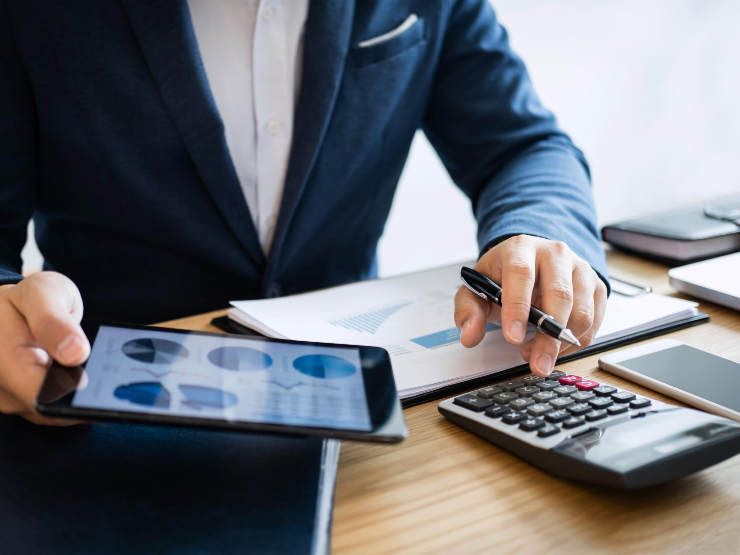 Lawyer reviewing accounting metrics on their tablet and double-checking numbers