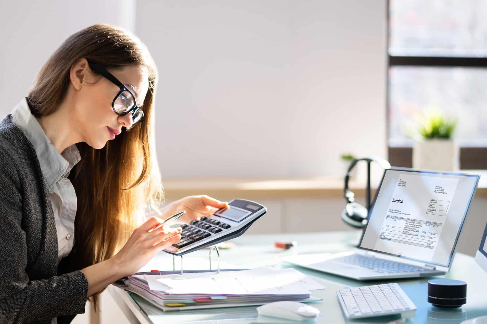 Person using calculator for finances