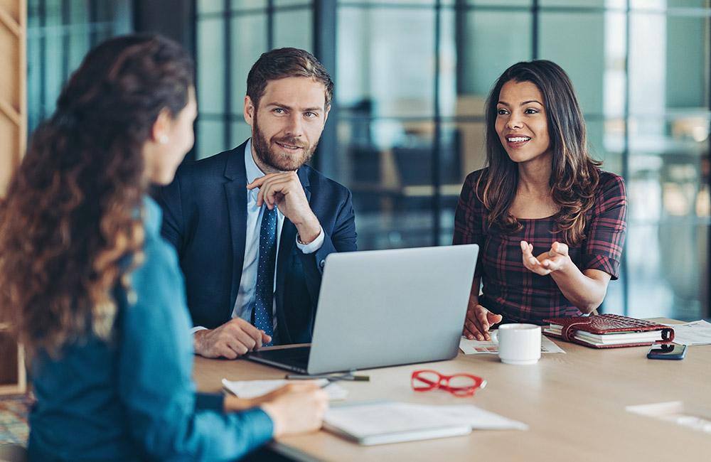 Law firm staff in a meeting to discuss their finances