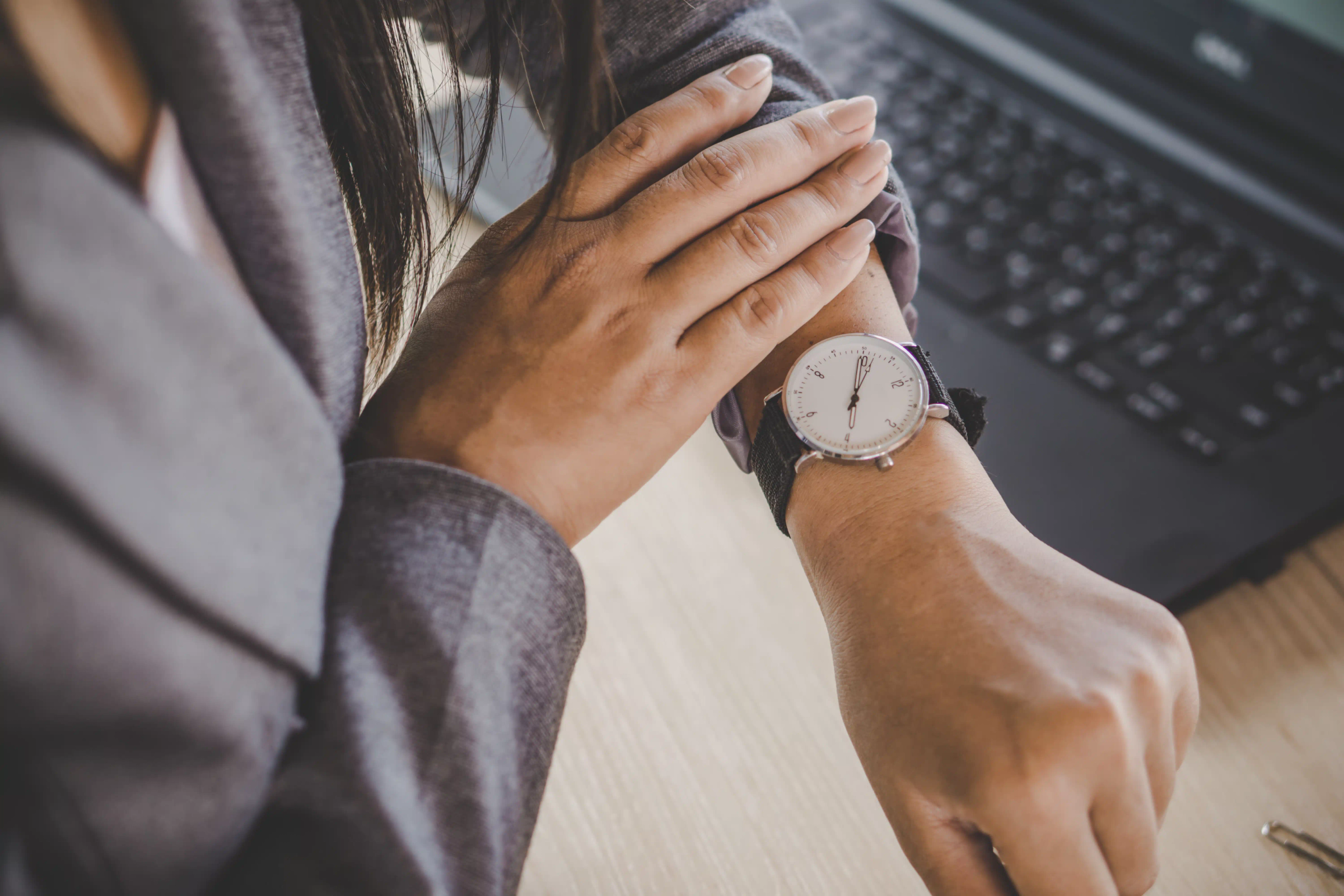 Person looking at time on watch