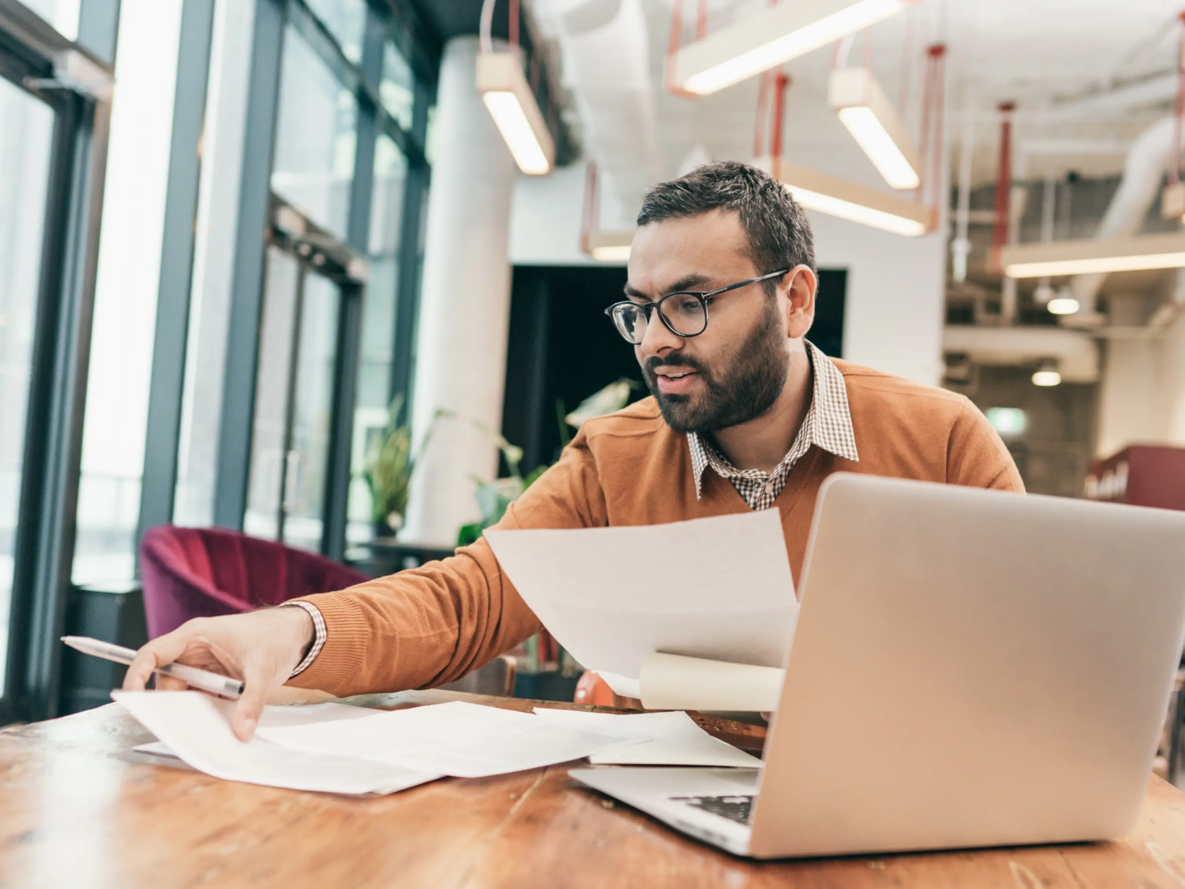 An accounting professional sifts through multiple documents.