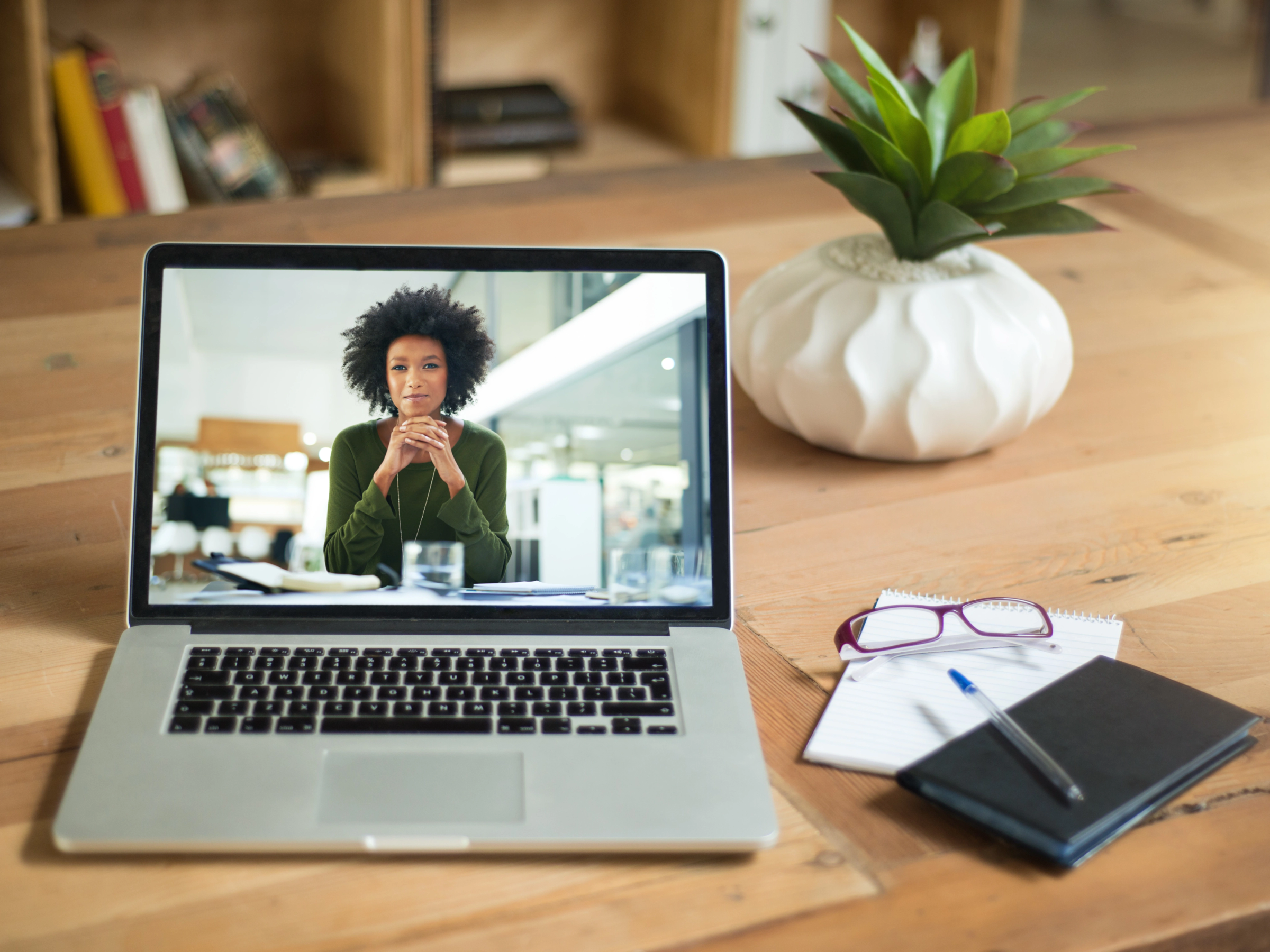 employee smiling in laptop monitor on web call