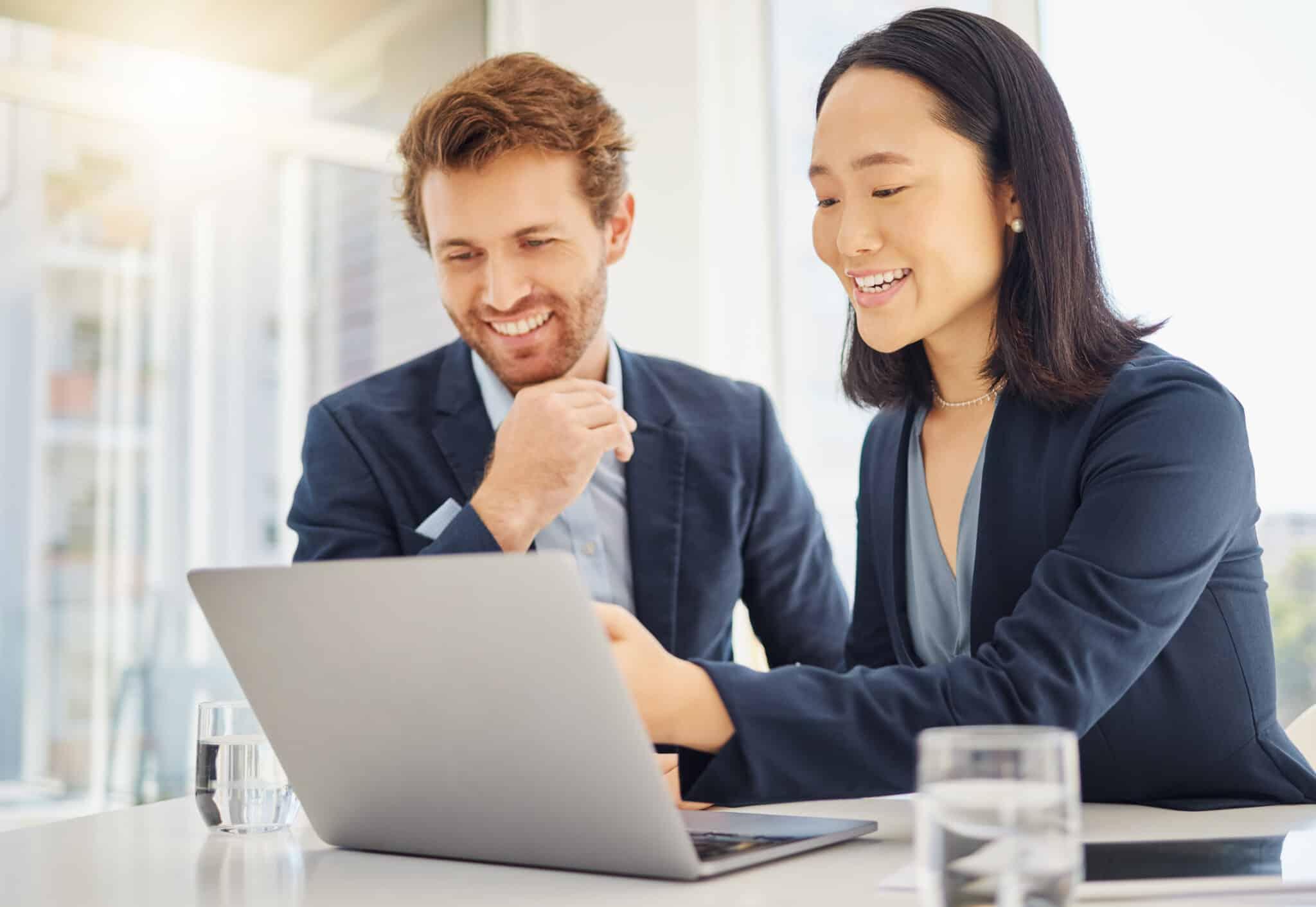 Team smiling at laptop