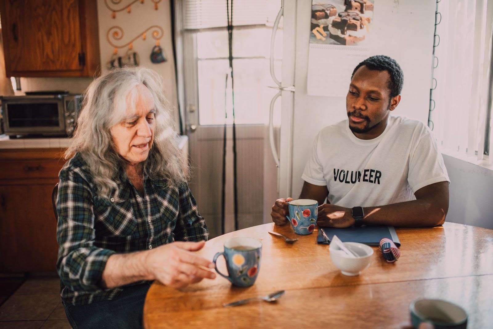 non profit worker speaking to immigrant at table