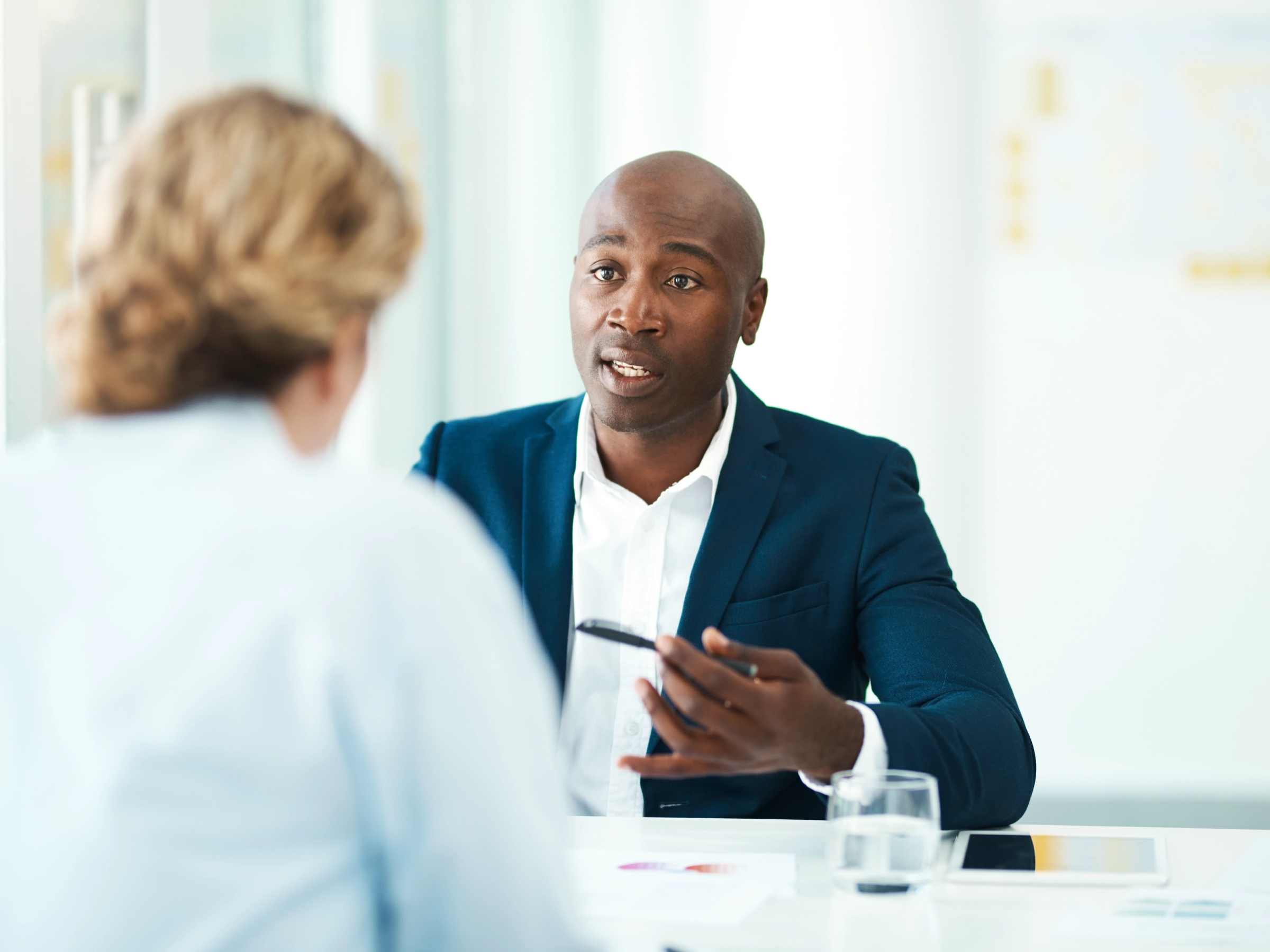 Solo practitioner meeting with a client in their office