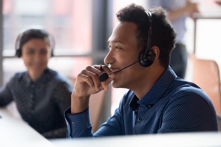 Man smiling on call with headset