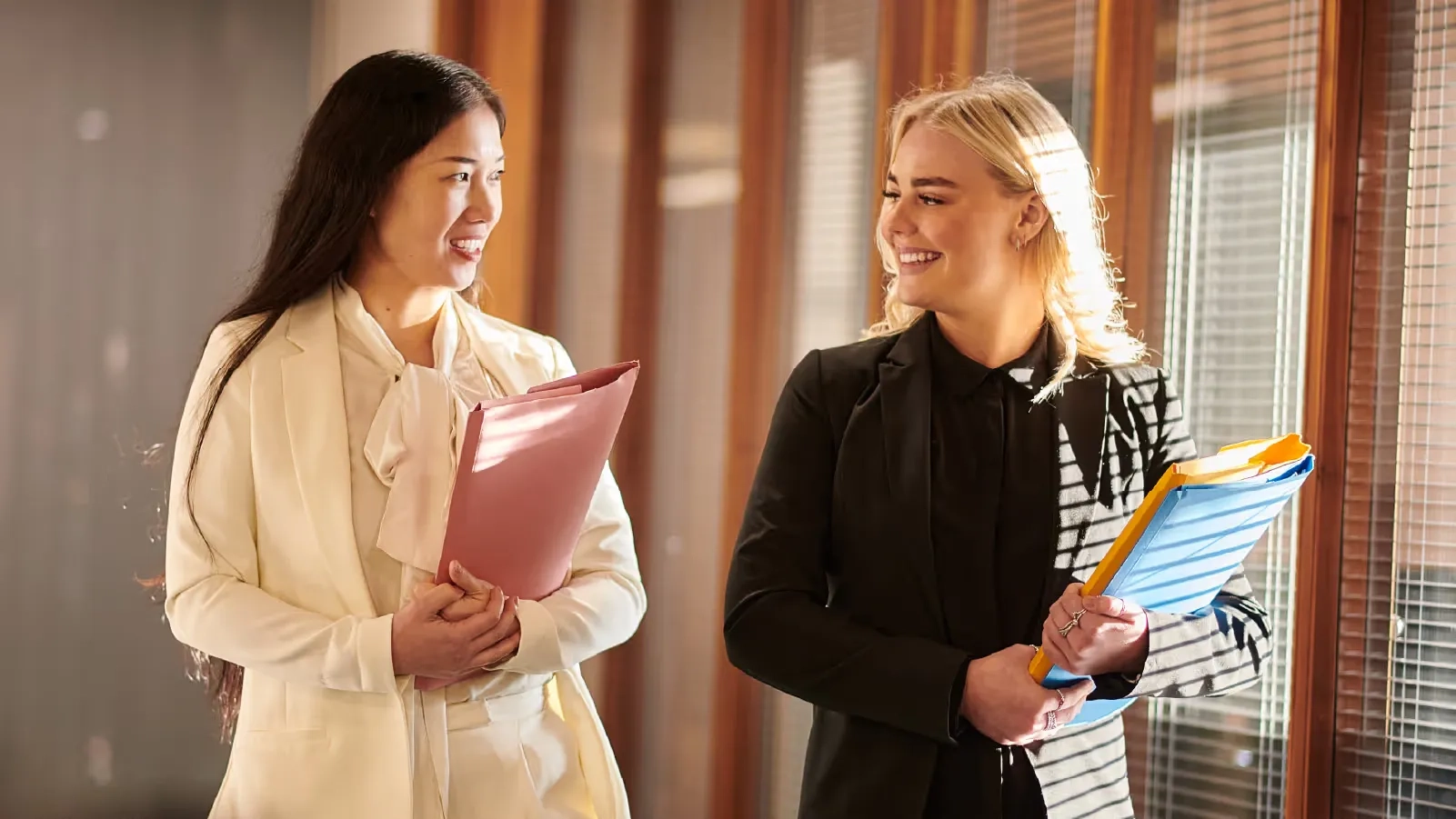 two women speaking as they walk