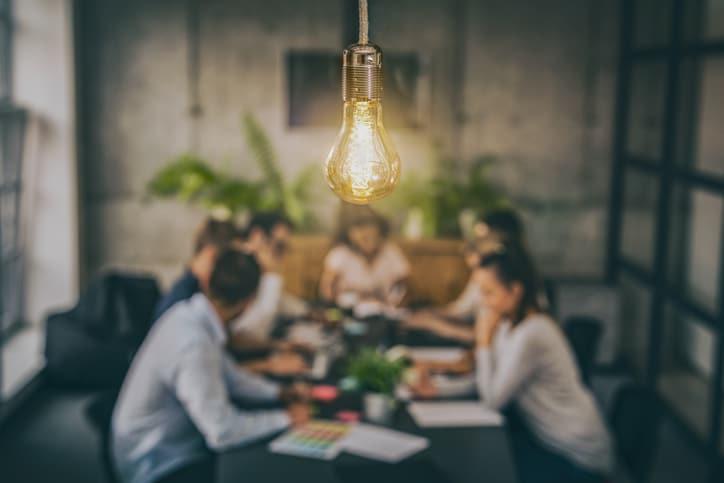 People conversing at meeting table