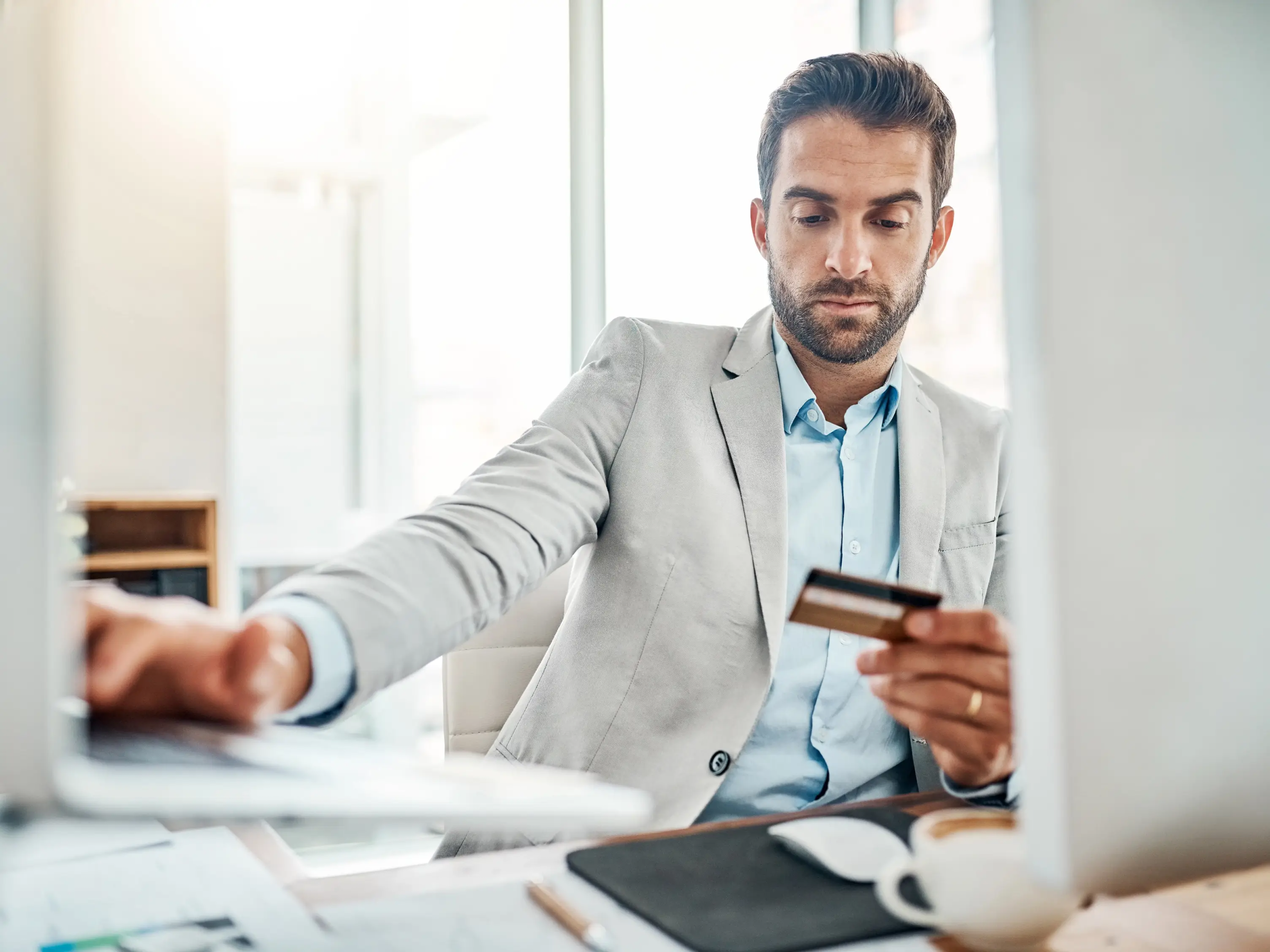 Lawyer reviewing a credit card at their desk