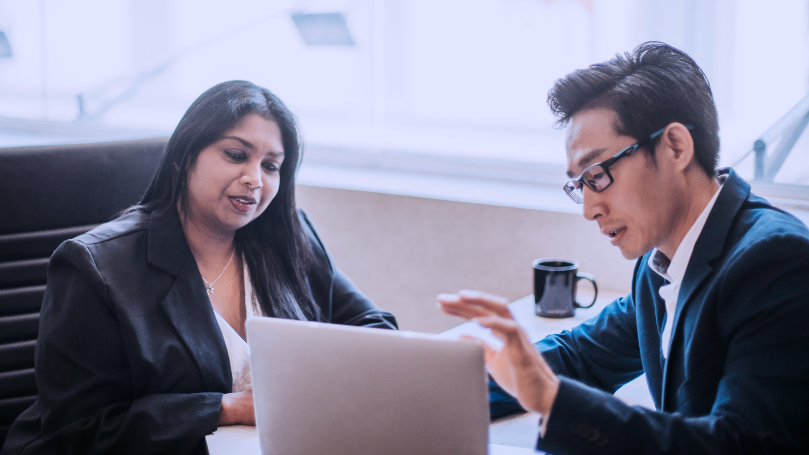 Two immigration legal professionals reviewing immigration forms