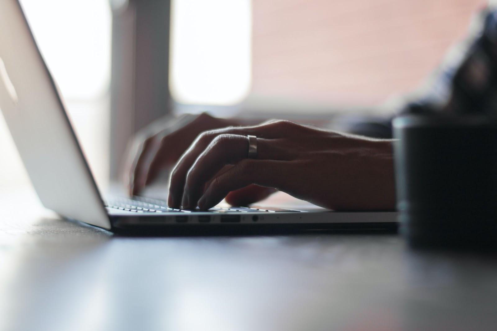 hands of an immigration lawyer adding client information to her software