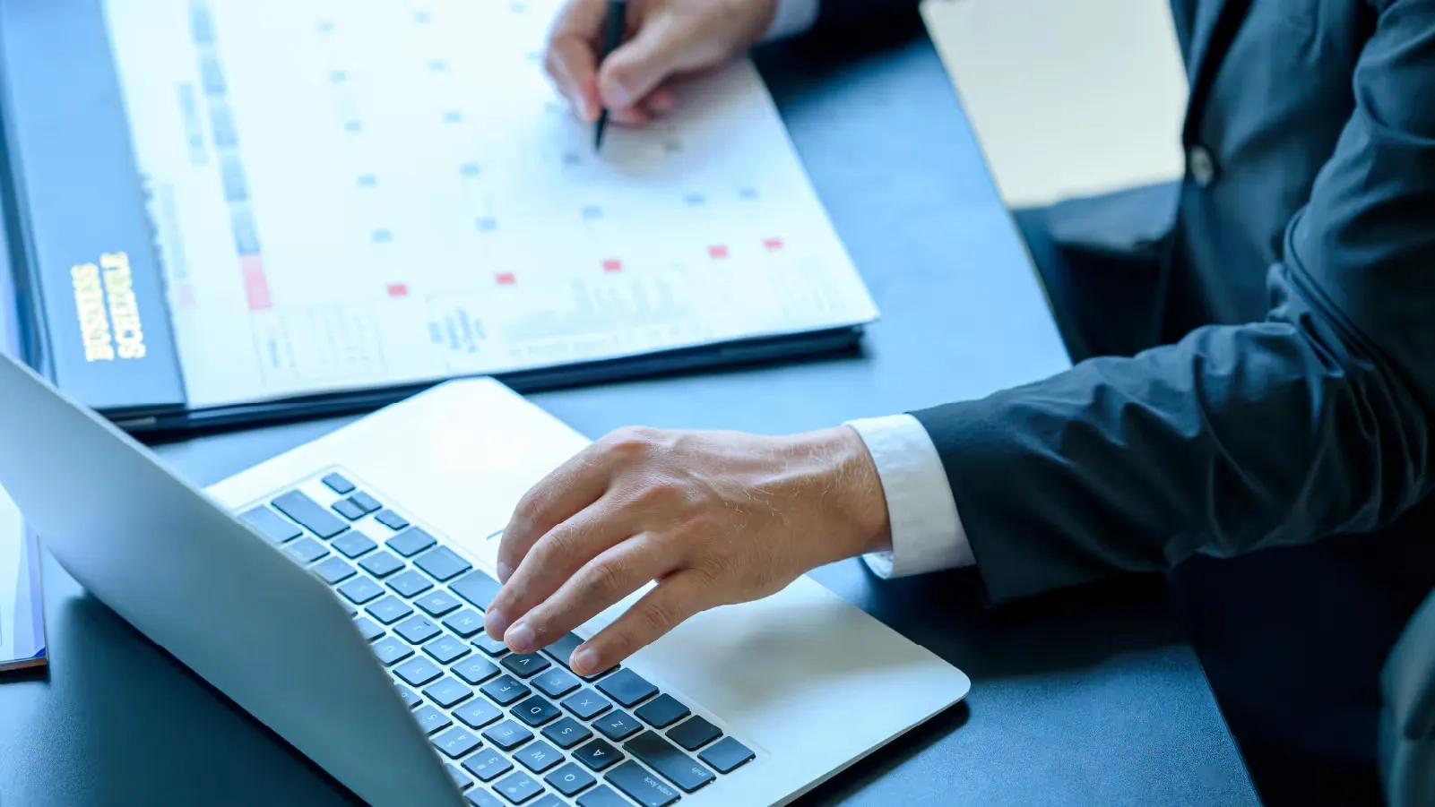 lawyer next to computer and writing in a calendar