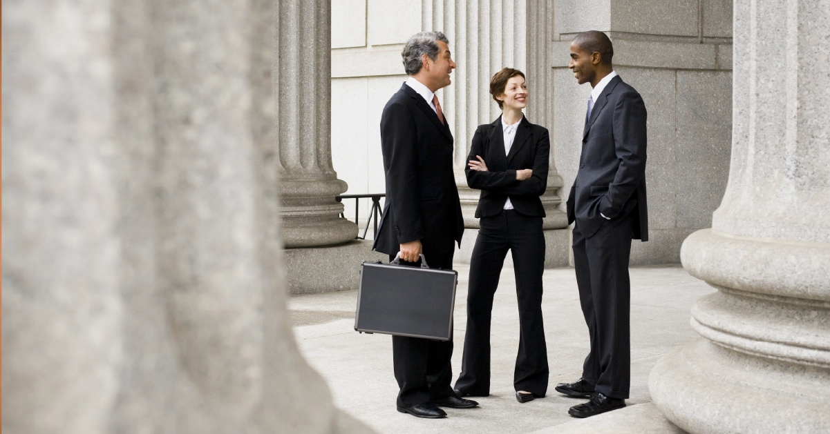 Lawyers talking outside of a courthouse