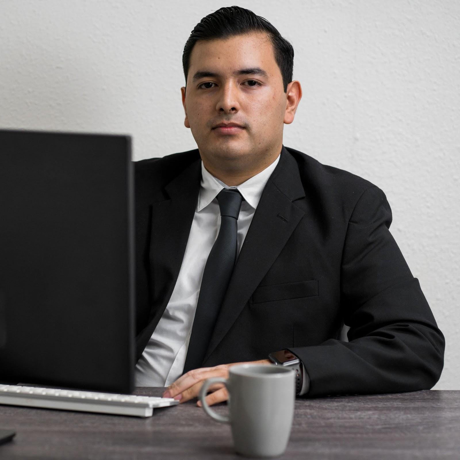 immigration lawyer sitting in front of his computer