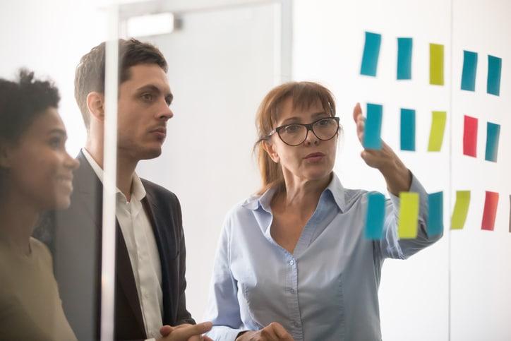 People strategizing with sticky notes