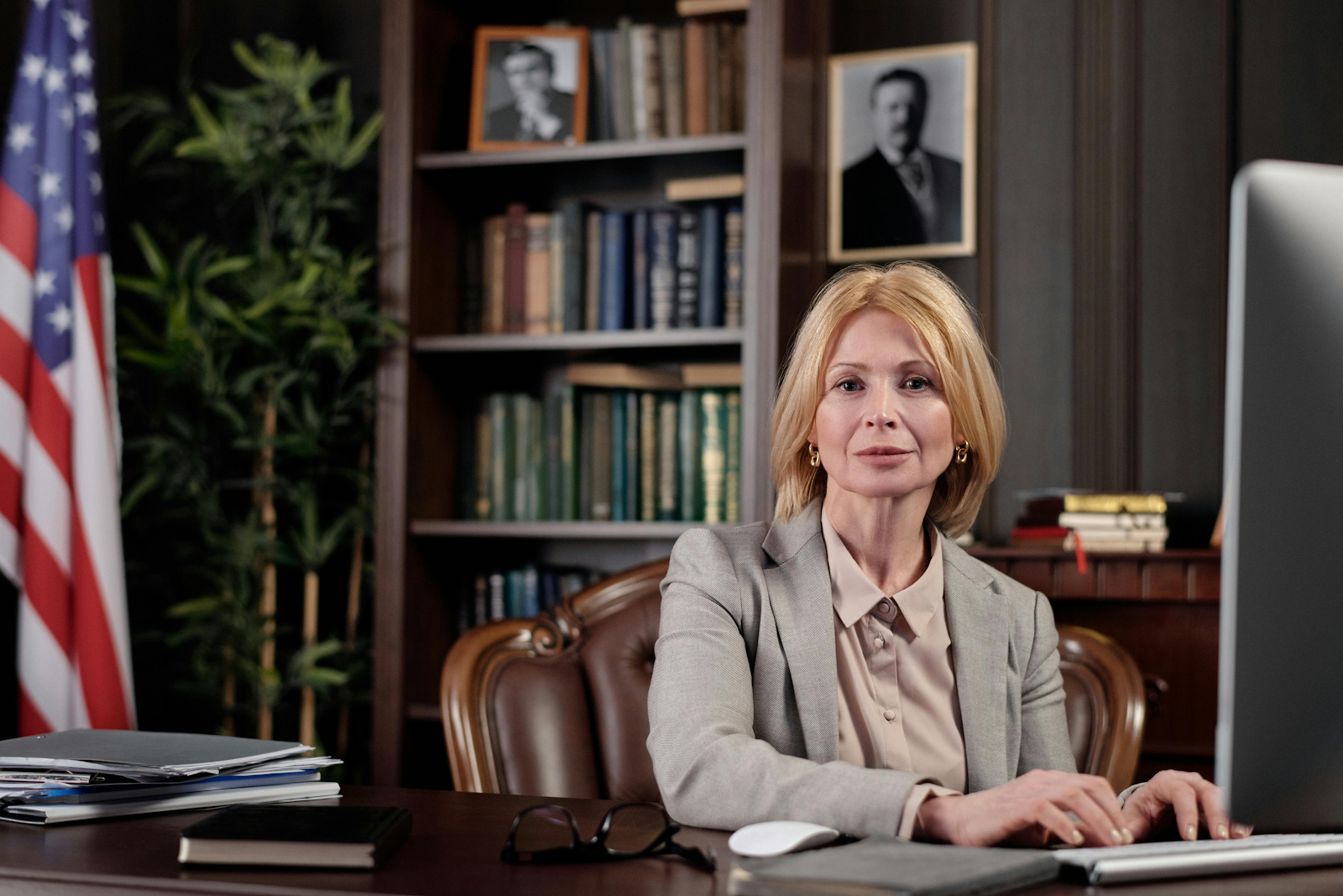 professional woman looking into camera with American flag on side
