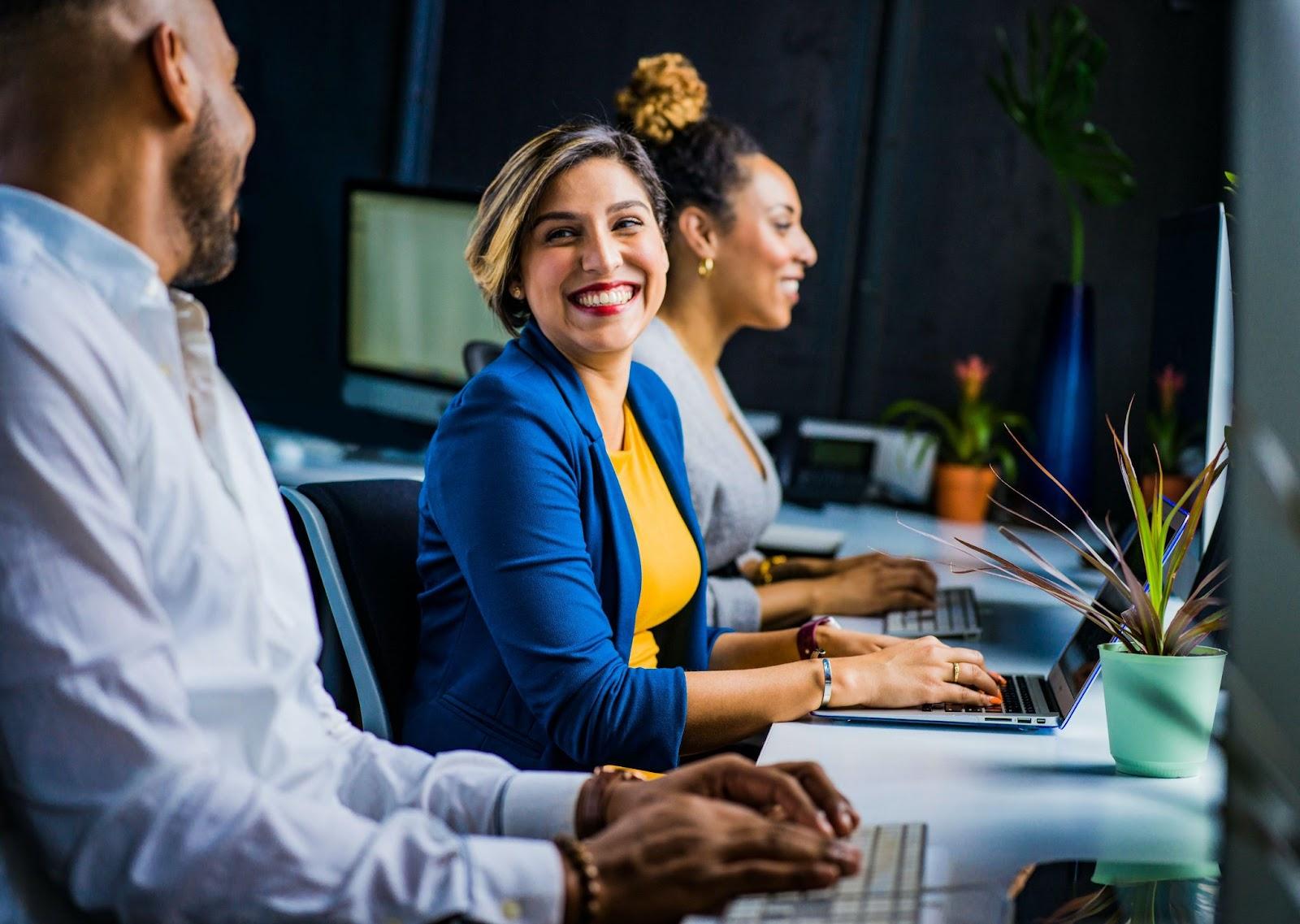 immigration lawyers smiling behind the computer