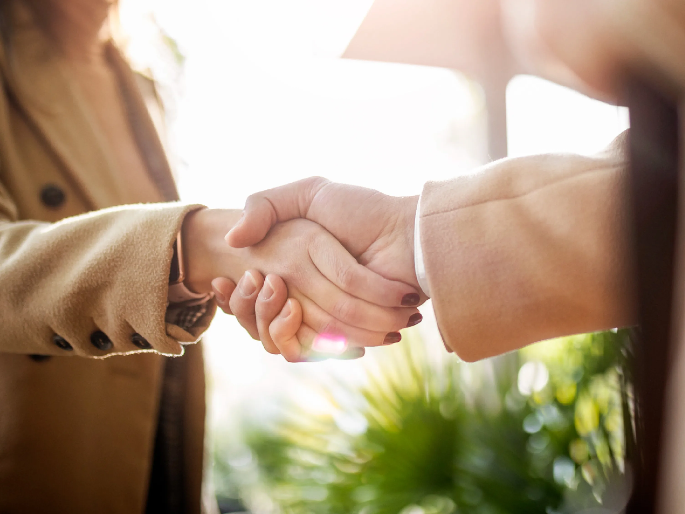 Two people shake hands