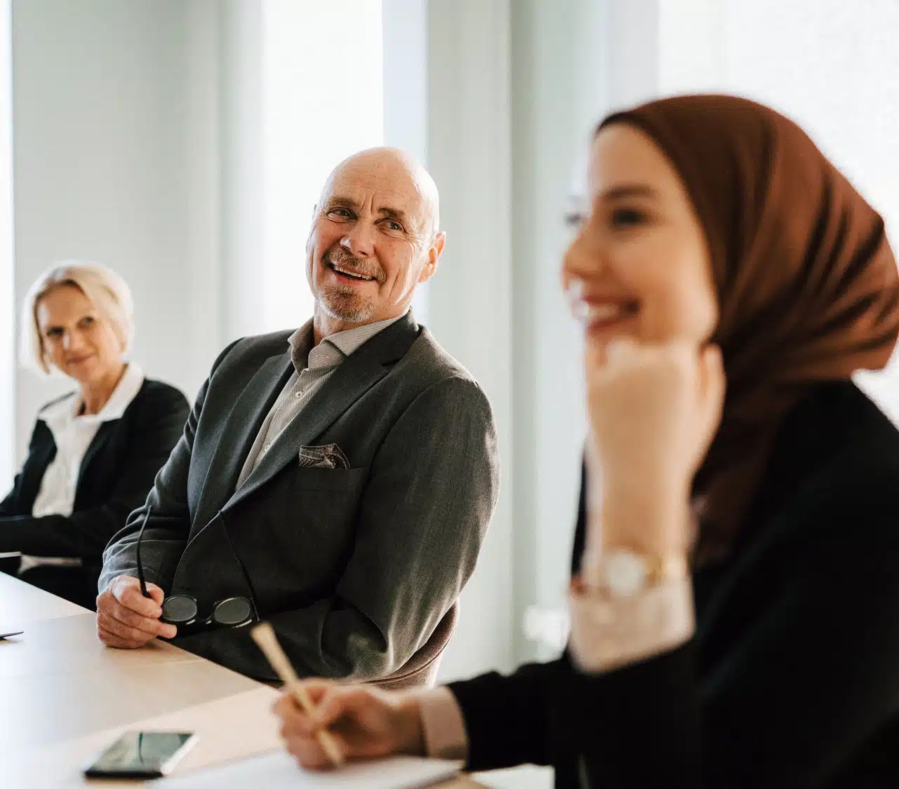 People smiling in board room