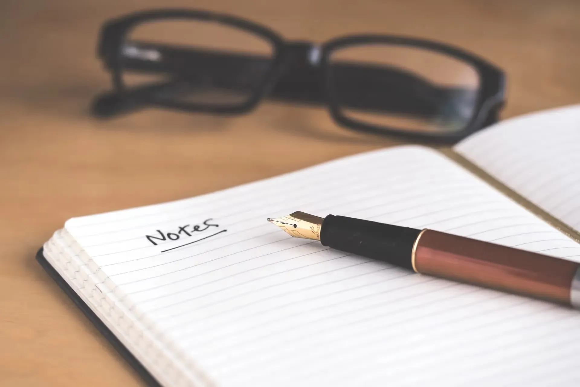 glasses and pen on notebook