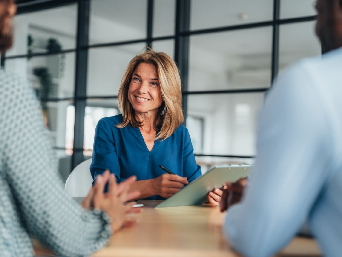 Happy lawyer discussing immigration forms with clients