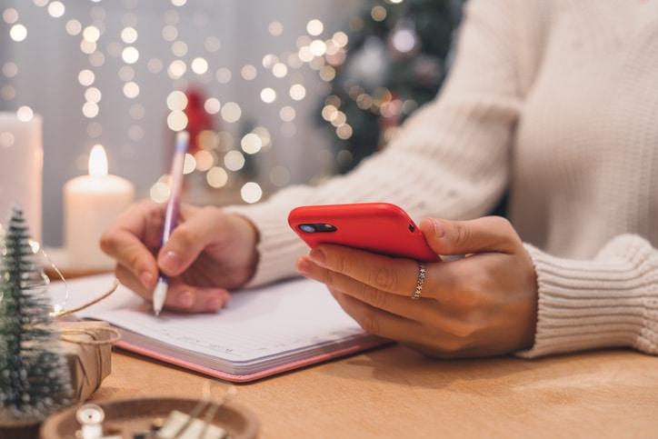 Person writing their New Years checklist