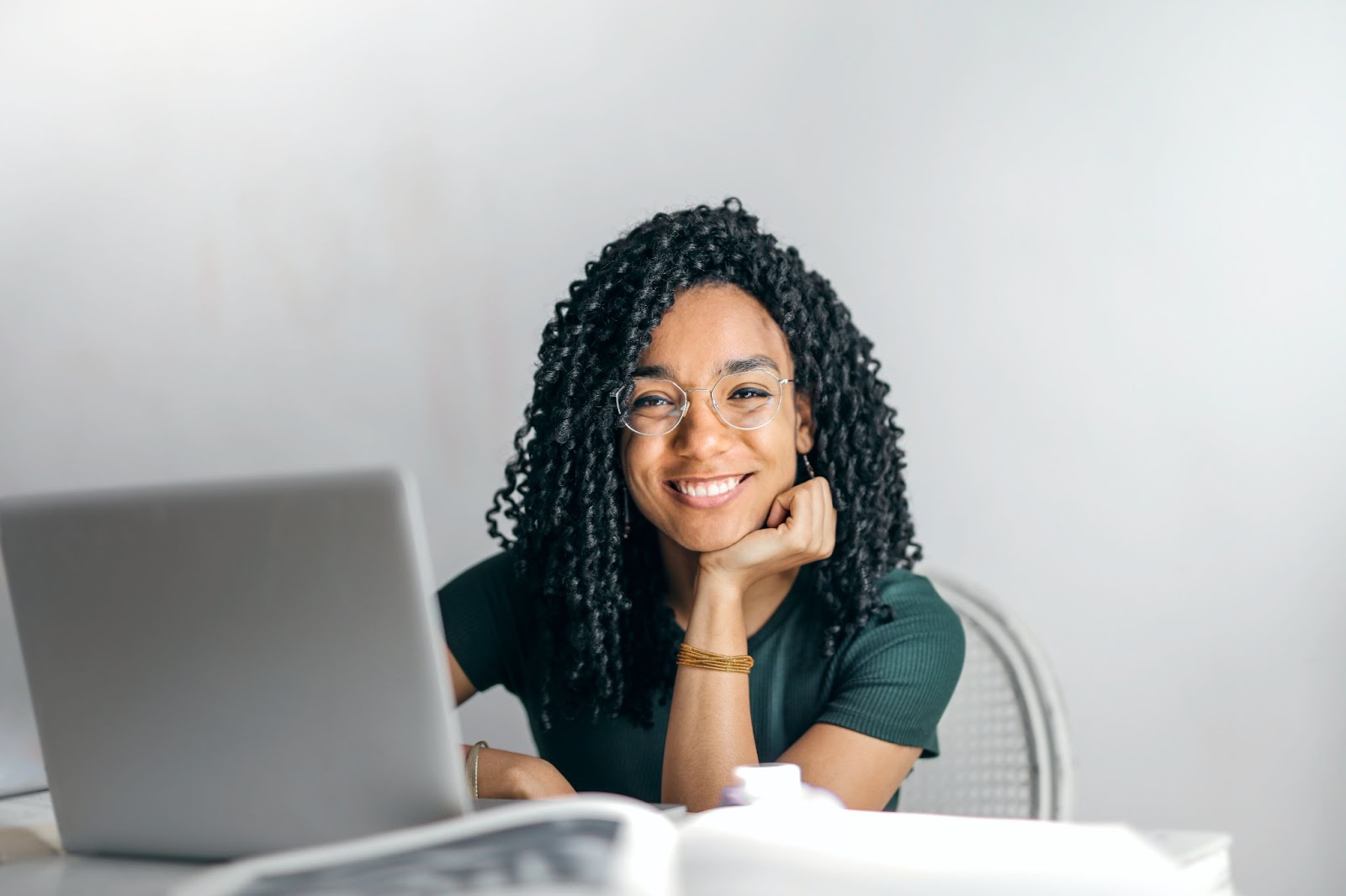 woman smiling in front of her computer