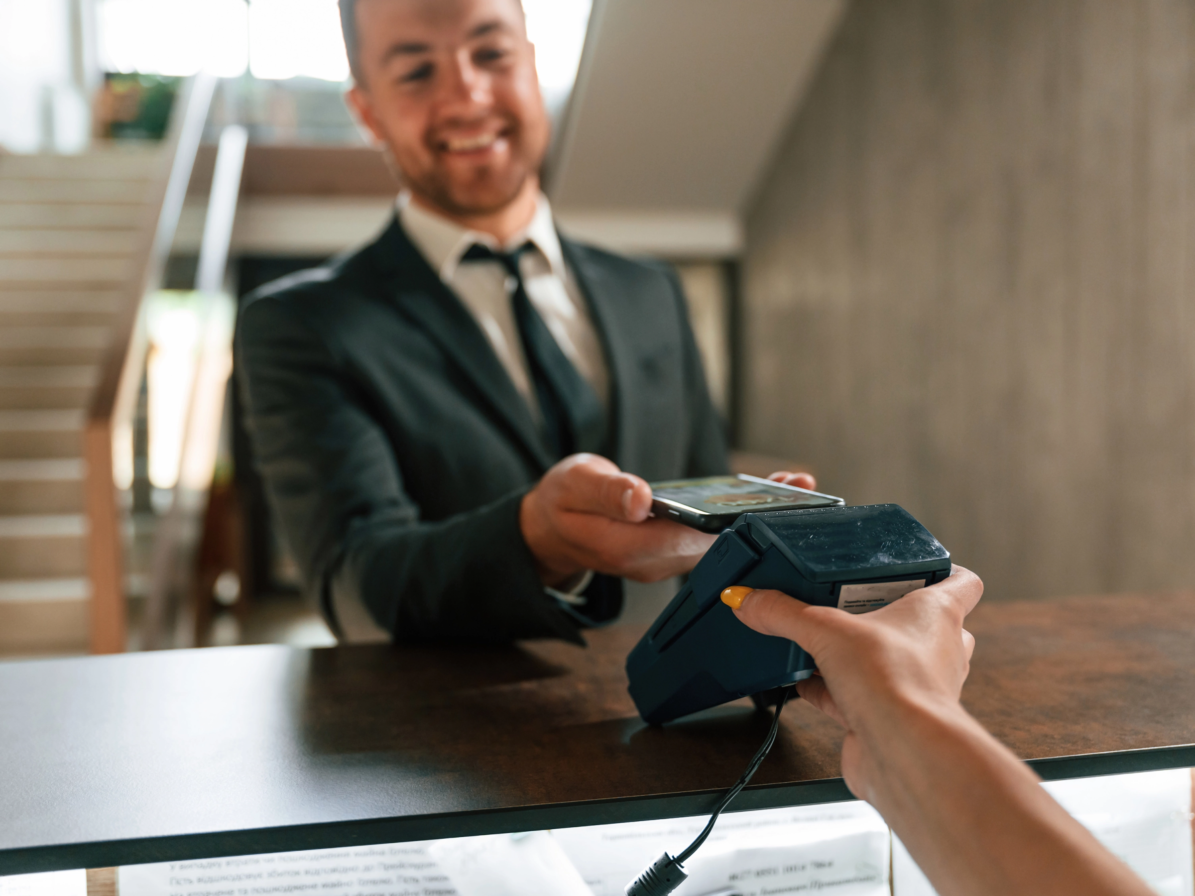 Person using tap-to-pay in a lawyer’s office