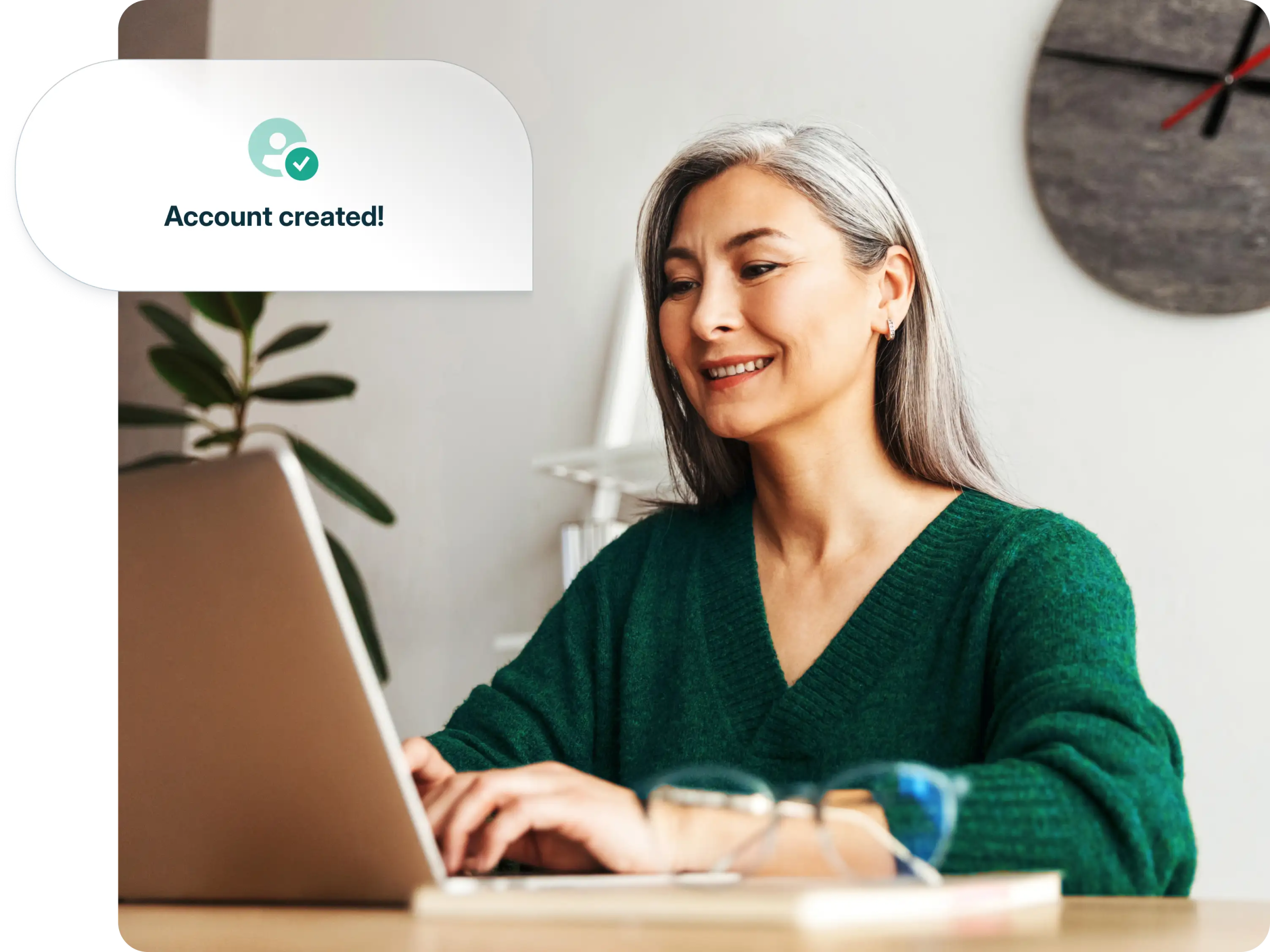 A woman smiles as she gets a notification saying her account has been created