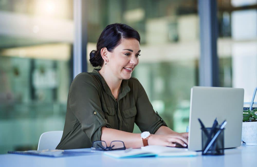 Person smiling at laptop