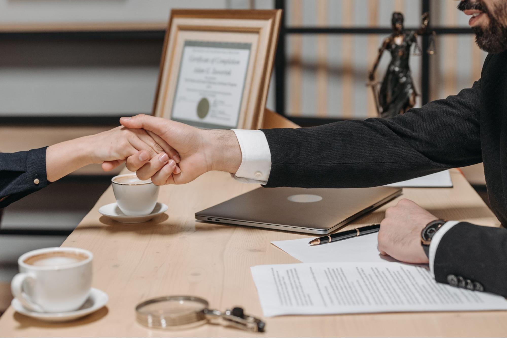 lawyer shaking client hand