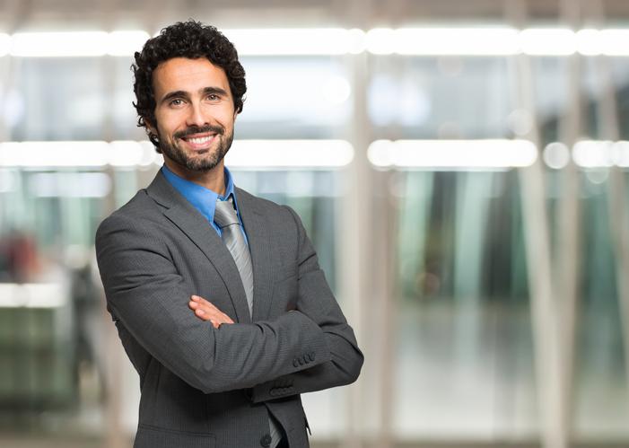 Man posing in suit smiling
