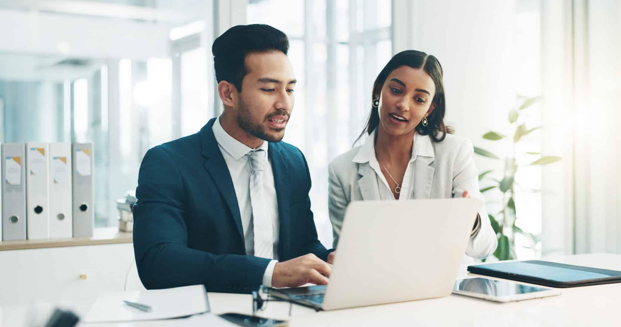 Two people collaborating on laptop