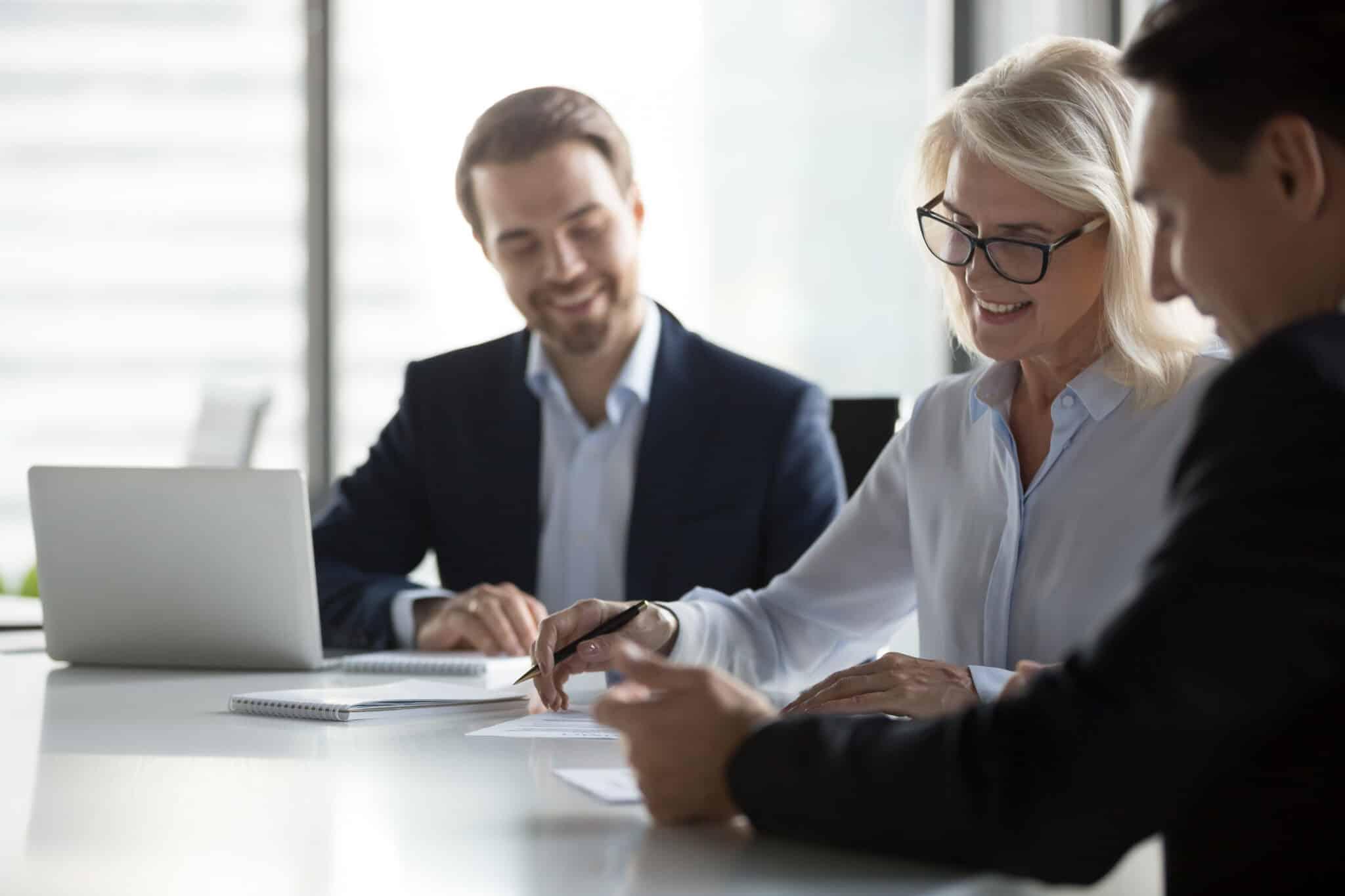 Three employees sitting in a meeting room