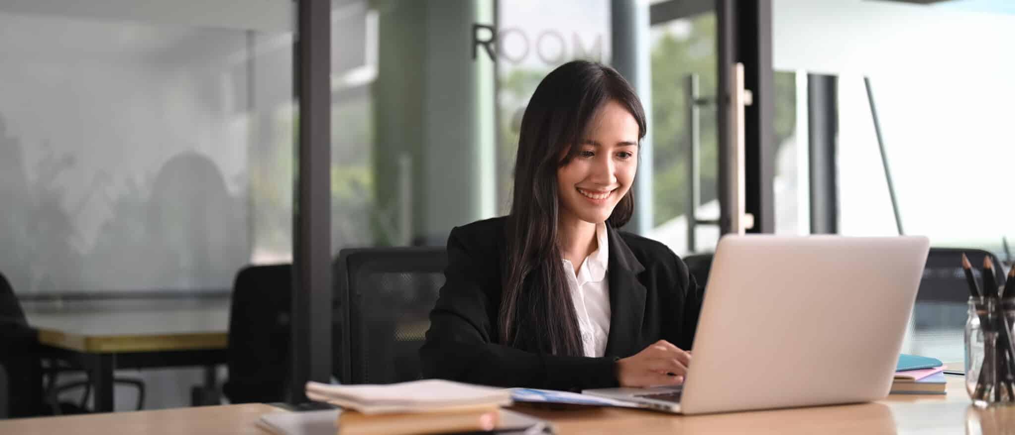 Woman smiling at laptop 