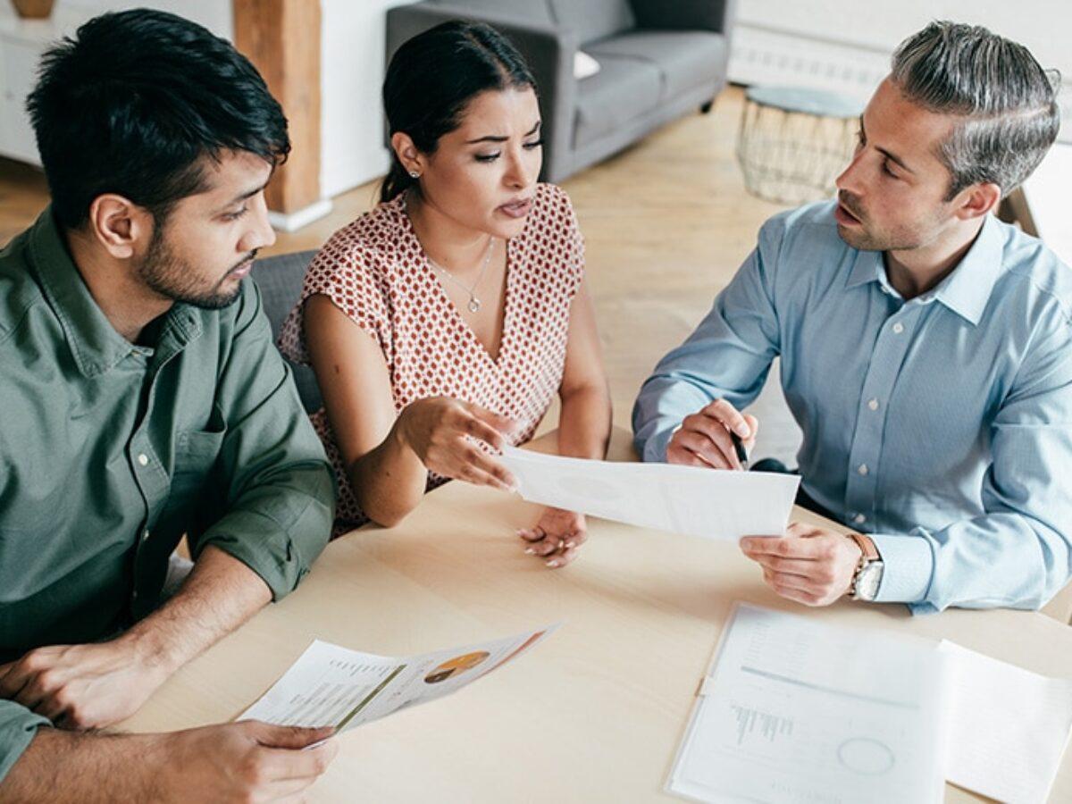 Lawyer meeting with a client in their home and discussing a payment plan