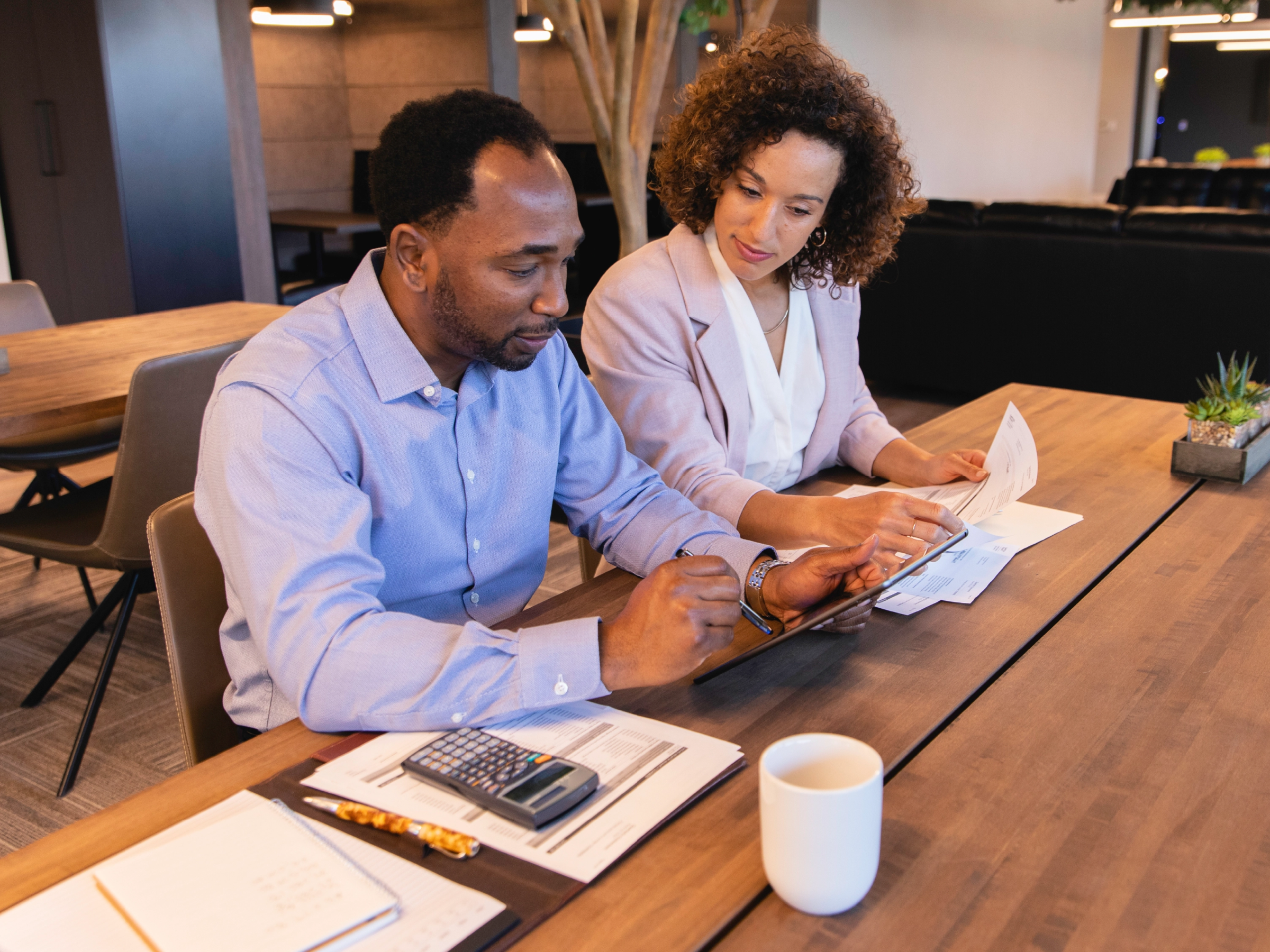 A professional attorney in an office setting with a tax professional 