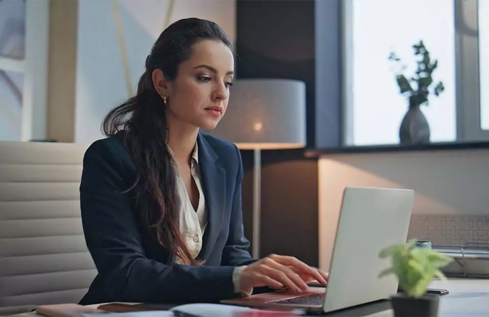 Lawyer scrolling on their computer in their office