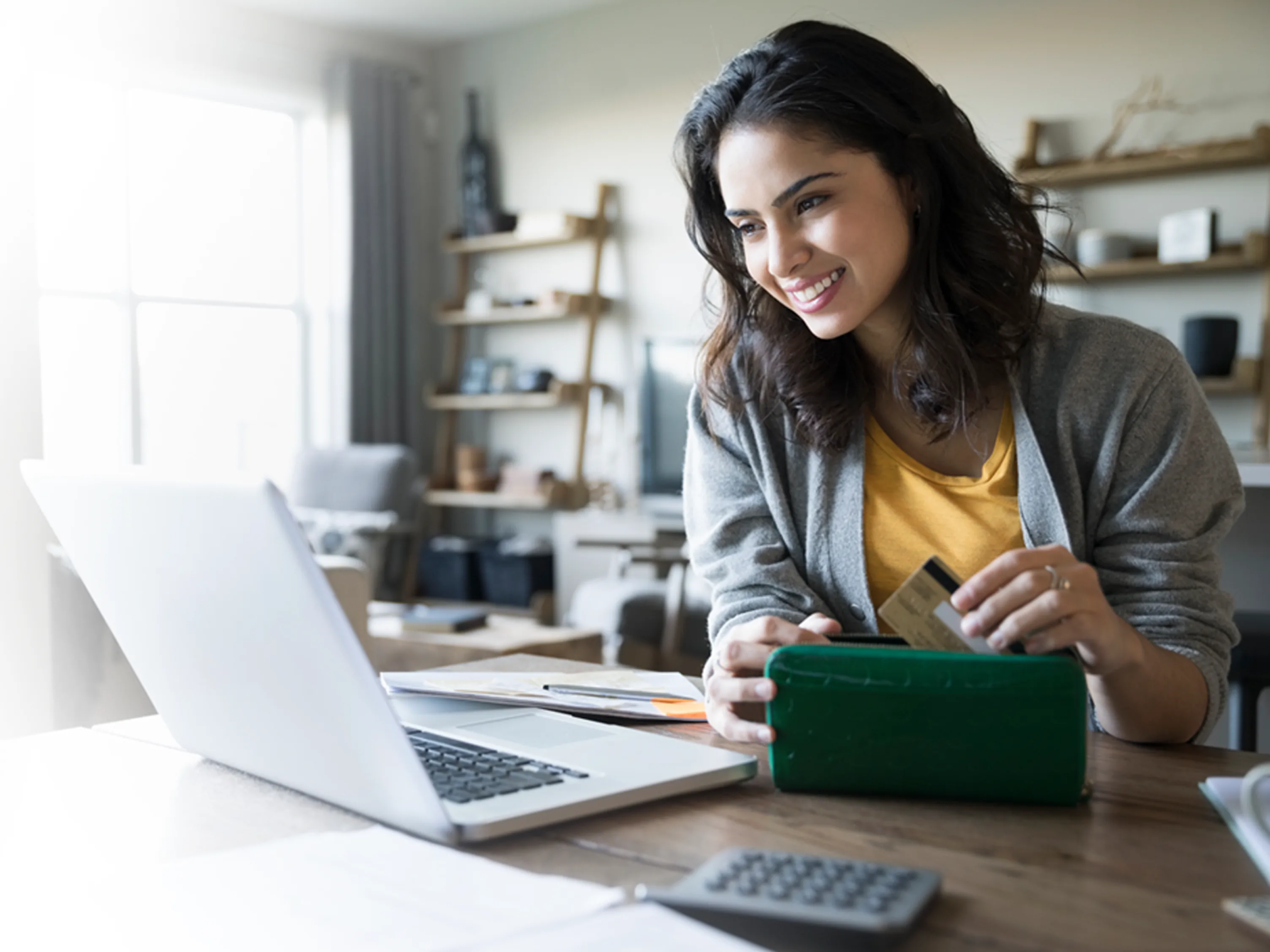 A women takes out her credit card for an online payment