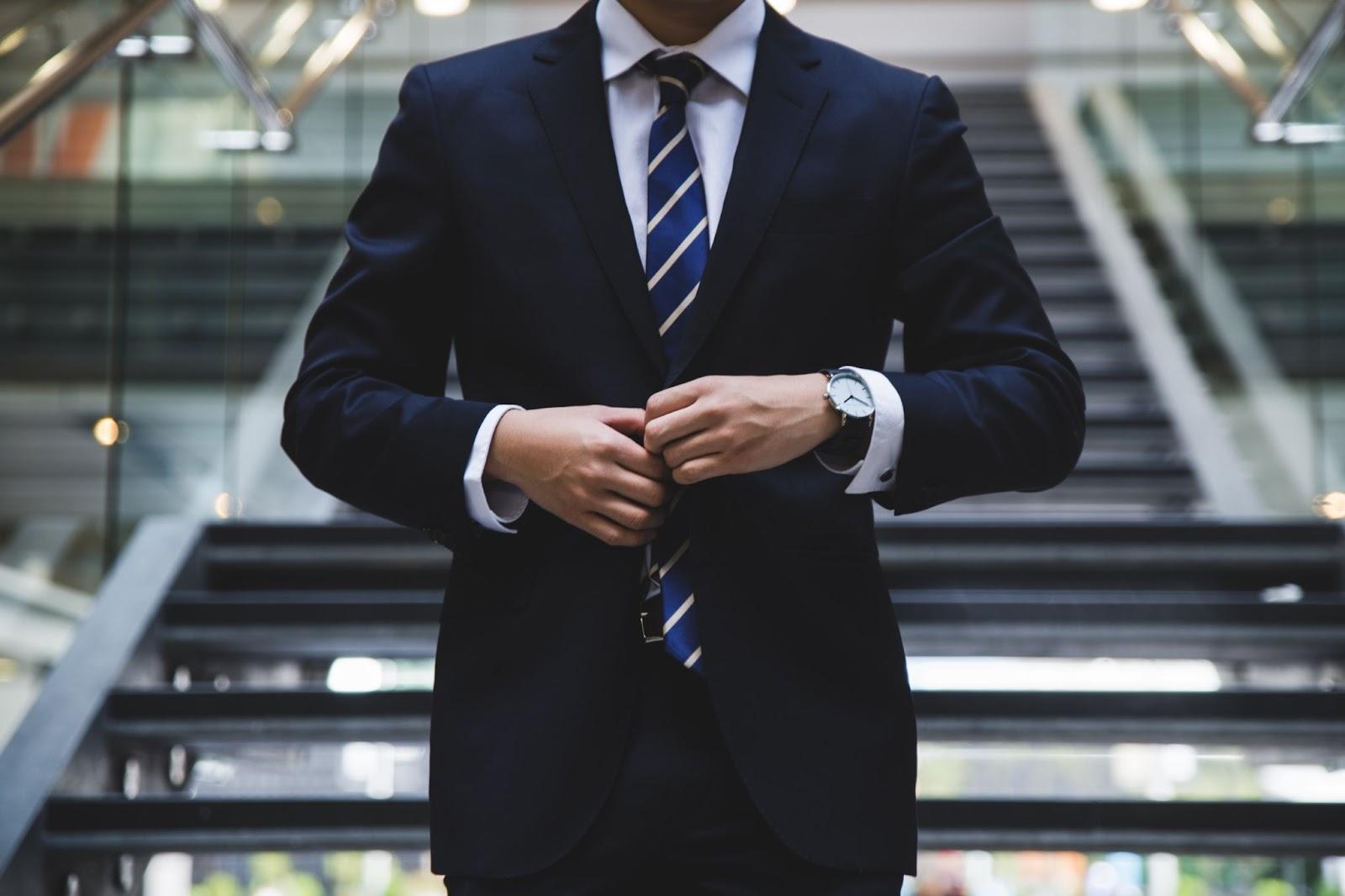 attorney wearing a suit and watch to demonstrate being efficient with his time