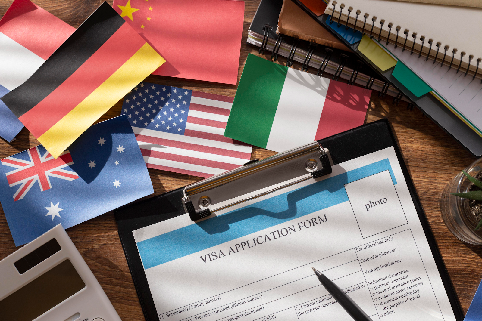 Desk with visa application forms and other important documents.