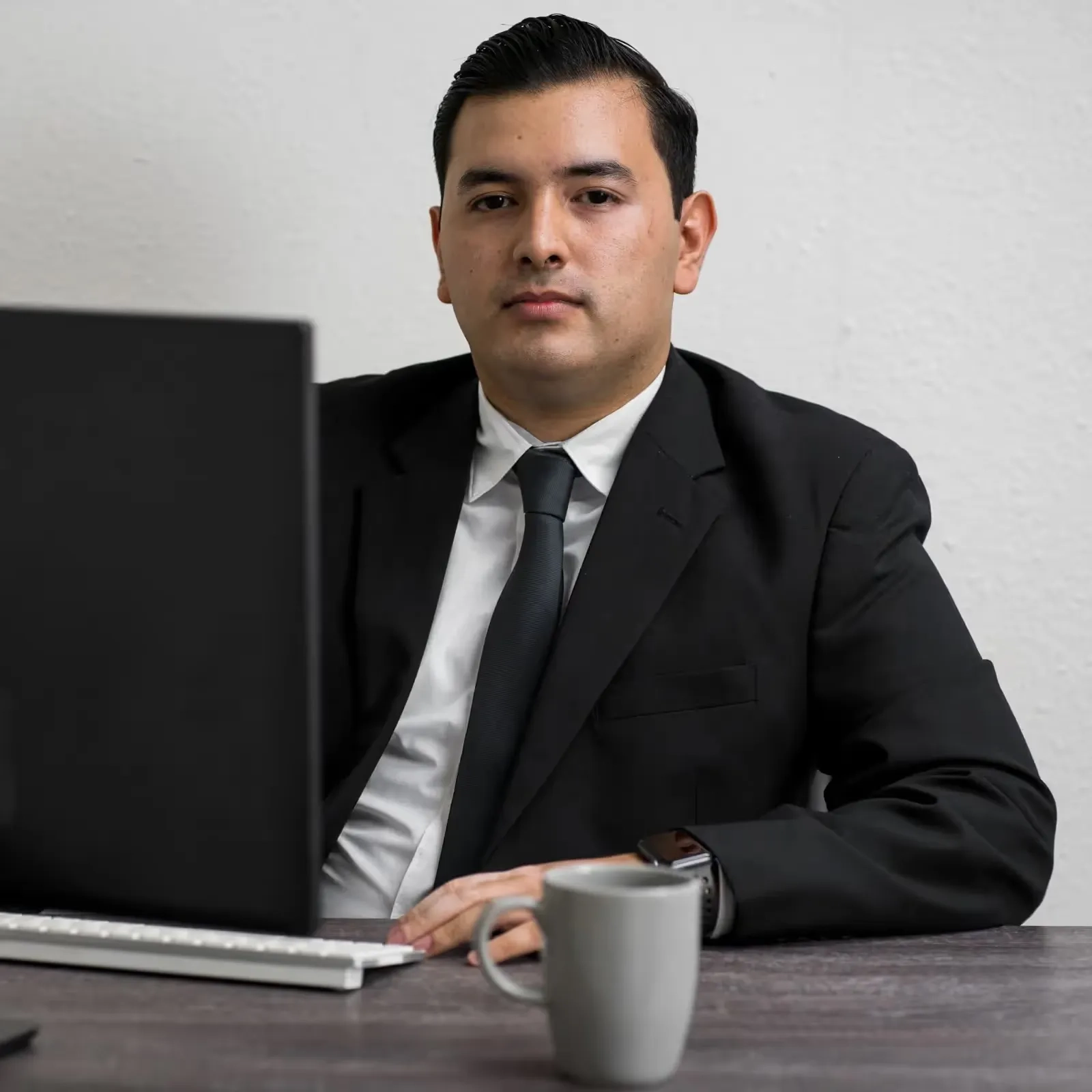 person sitting in a desk in front of a laptop