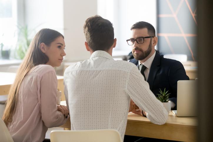 People conversing in meeting room